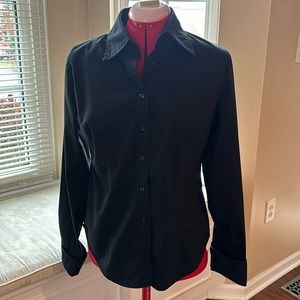 Black button down shirt with cuffed sleeves.